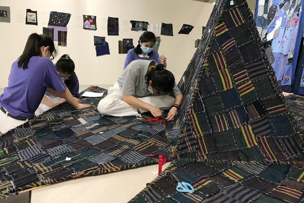 Tzu Chings are forming the roof of the “house” using the triangular shaped artwork made by Jimmy.  (Photo provided by Jimmy Ong) 