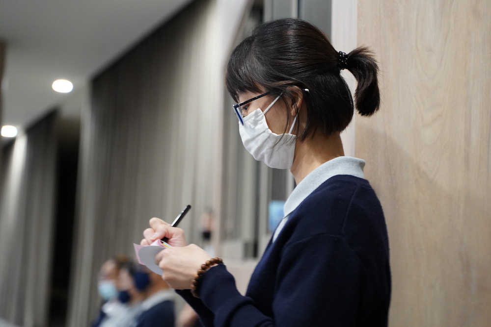 As a volunteer writer, Ms Leong can often be seen meticulously jotting down notes of the events that she covers. (Photo by Wang Hai Yang)